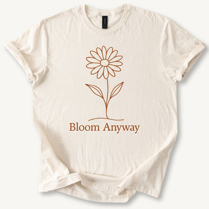 A natural colour t-shirt with a terracotta line-art flower graphic and 'Bloom Anyway' text underneath.