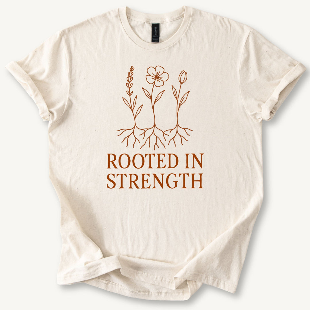 Beige t-shirt with 'Rooted in Strength' text and floral design on a white background